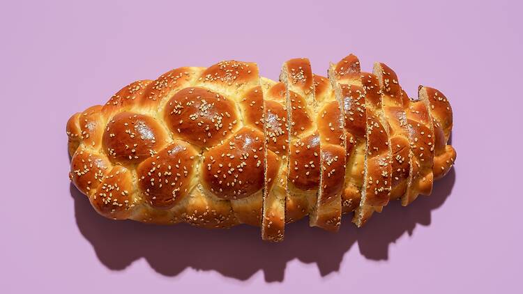 Loaf of challah against purple background Loaf of challah against purple background