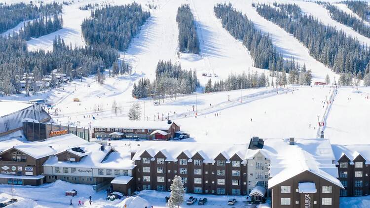 SkiStar Lodge Lindvallen and Ski Slopes in Sälen, Sweden Snow-covered SkiStar Lodge with ski lifts and mountain slopes under a clear winter sky in Lindvallen, Sälen, Sweden.