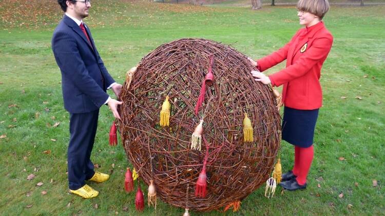 Artists Tomas Klassnik and Riitta Ikonen with their giant seedball used to 'draw' upon the landscape