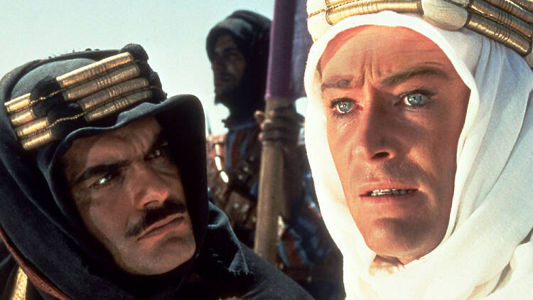 A still from the film Lawrence of Arabia of two men talking to each other wearing Arabian clothing