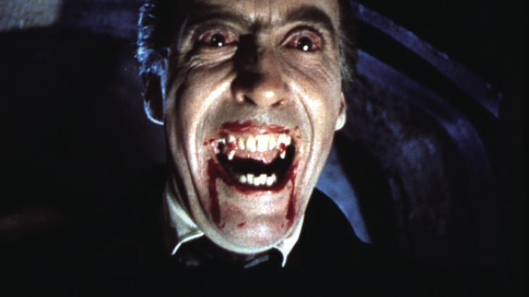 A still from the film Dracula of Christopher Lee as Dracula baring his bloody fangs