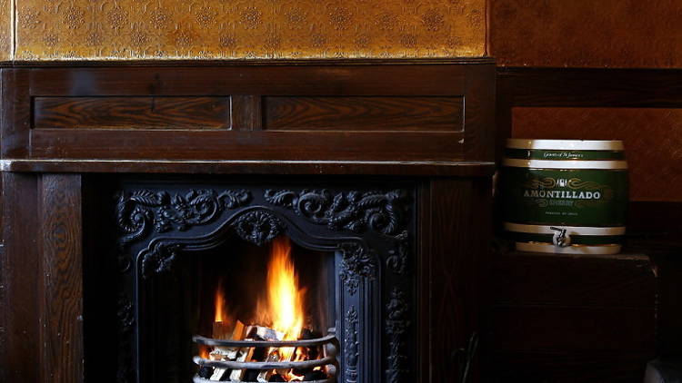 Grab a seat by the fire at The Holly Bush